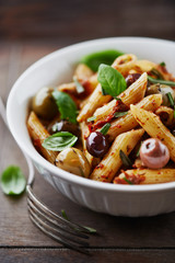 Penne pasta with dried tomato pesto and marinated olives