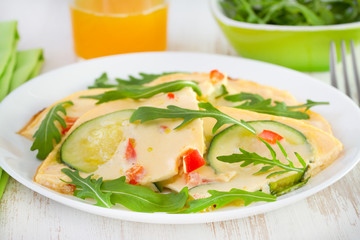 omelet with zucchini on the plate and orange juice