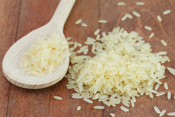 rice on spoon on the old table