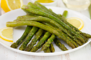 asparagus with lemon on white plate