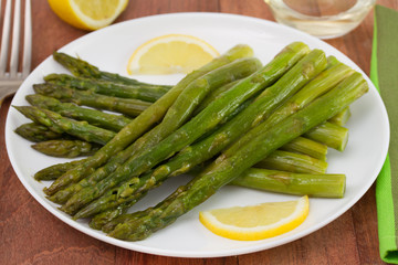 fried asparagus with lemon on the plate