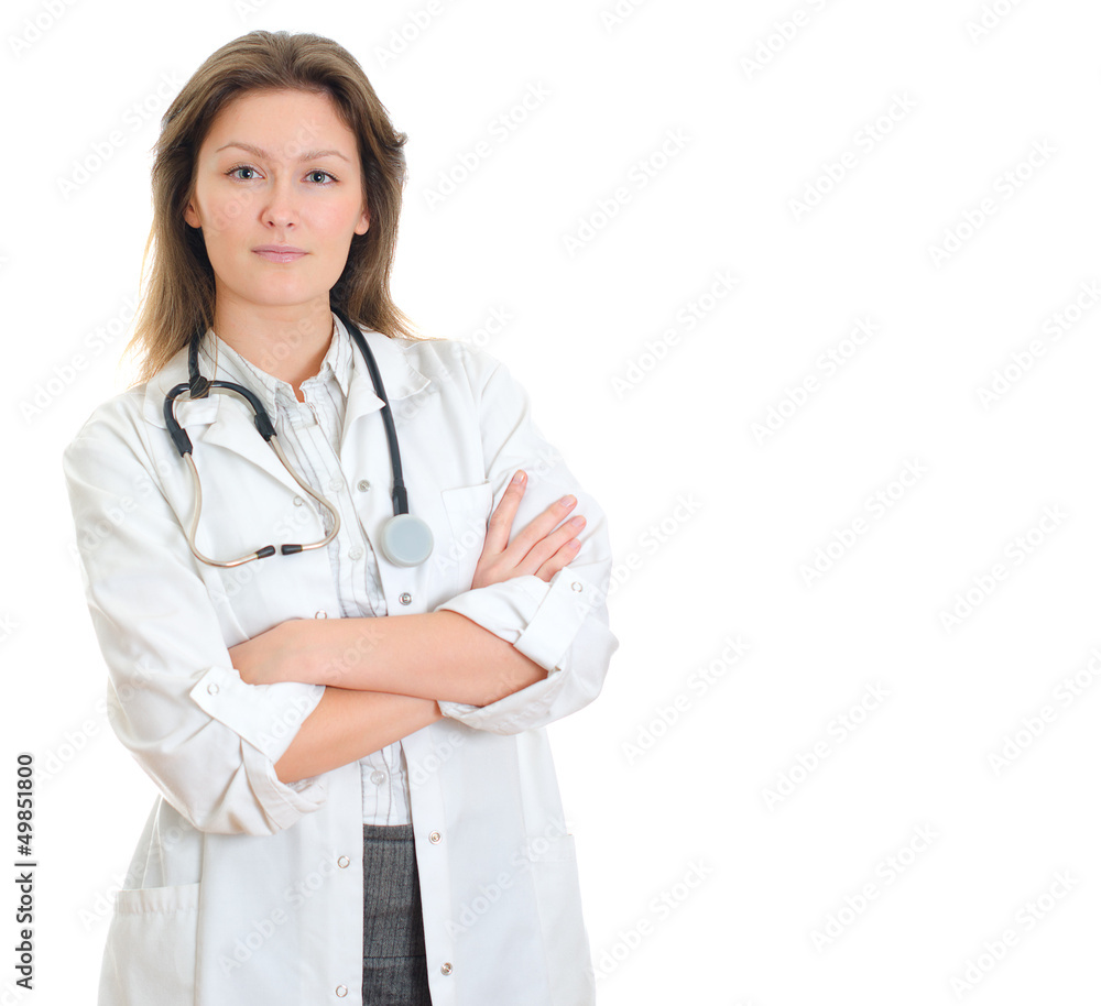 Wall mural Young pretty female doctor in uniform over white background