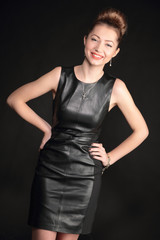 glamorous smiling girl in leather dress