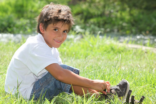 Child Sitting In A Field