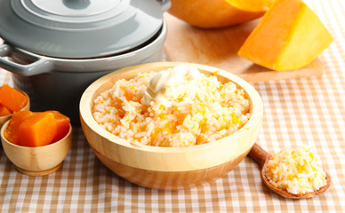 Taste rice porridge with pumpkin in bowl