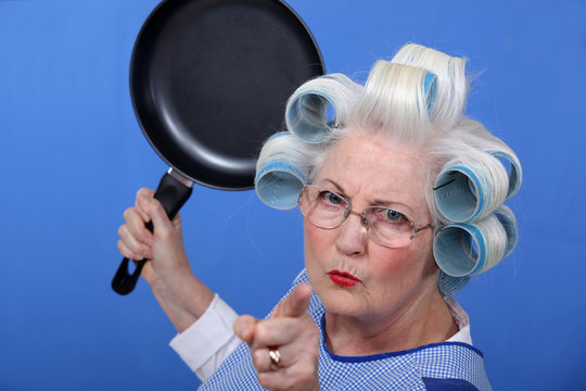 Angry old woman with a frying pan