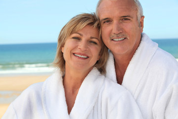 Couple at the beach in bathrobes