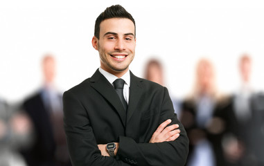 Smiling executive in front of his team