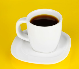 A cup of strong coffee on yellow background