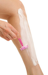Fototapeta na wymiar Beautiful woman is shaving her leg, isolated on white