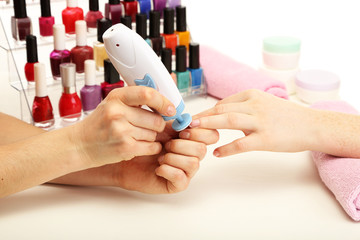 Manicure process in beauty salon, close up