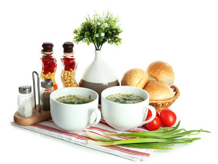 Fragrant soup in cups isolated on white