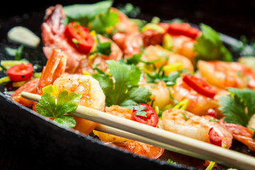 Closeup of tasting Fried shrimp with chopsticks