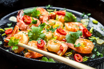 Chopsticks and fried shrimp with herbs