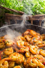 Hot shrimp fried in a pan with herbs