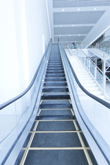 Escalator in modern interior toned