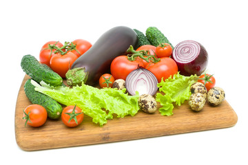 fresh vegetables on a cutting board on a white background