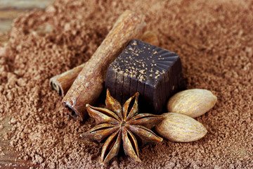 Chocolate sweets with cocoa, on brown background