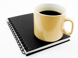 Morning coffee on black notebook