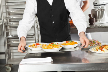 Waiter Holding Pasta Dishes In Tray
