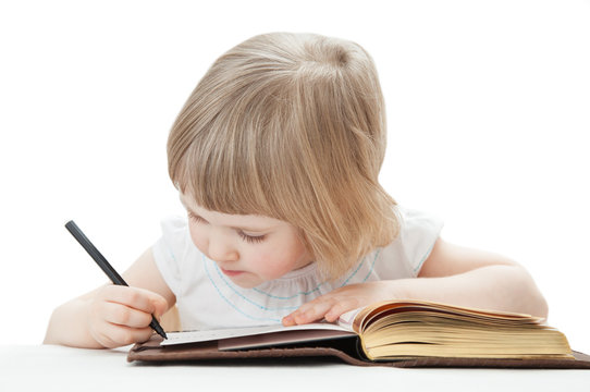 Little girl writing letters with a pen