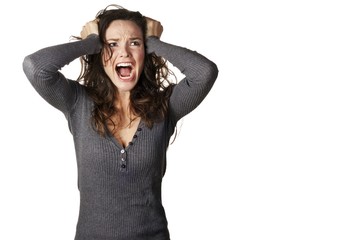 Frustrated and angry woman is screaming and pulling her hair
