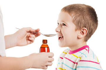 Doctor giving spoon of syrup to child boy