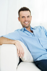 Fototapeta premium Portrait of smiling man on the sofa