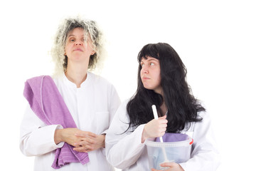 Female cleaners in white work coats