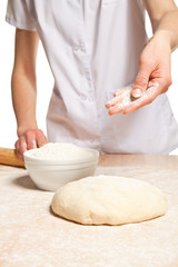 Woman's hands knead dough