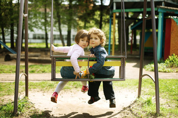 boy and girl on the swings