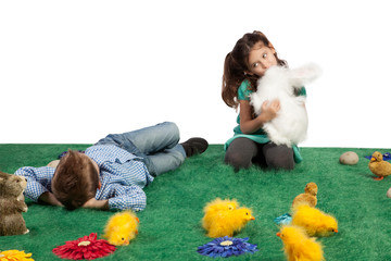 Young boy and girl with toy bunnies and chicks