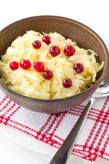 Sauerkraut salad with cranberries in a brown bowl