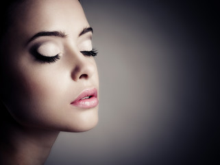 Fototapeta premium Young woman with beautiful makeup, face close-up.