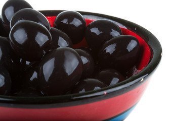 Olives black watered with olive oil in a bowl isolated on a whit