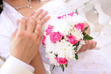 Wedding flower banch with newlyweds hands