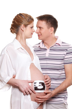 Happy pregnant family with ultrasound picture