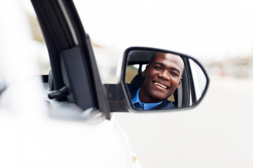 male african american driver looking at rear mirror