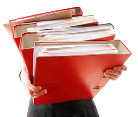 Female office worker carrying a stack of files