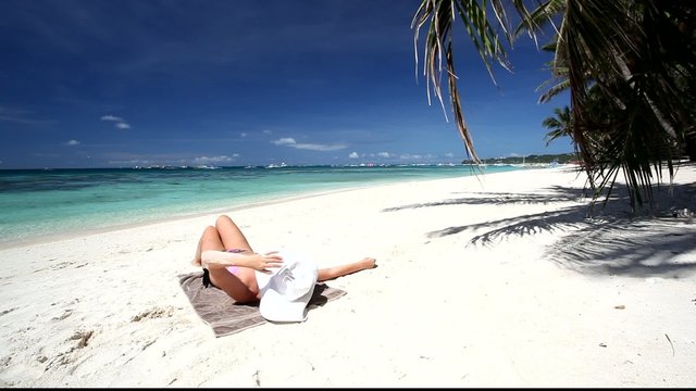 Woman relaxing on white beach, Boracay