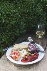 Meal served on a plate with a wineglass, Italy