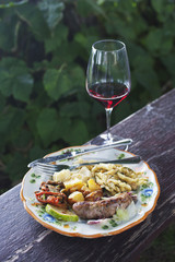 Meal served on a plate with a wineglass, Italy