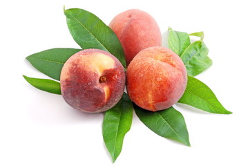 fresh peach fruits with green leaves