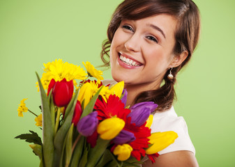 Portrait of a smiling woman with colorful flowers