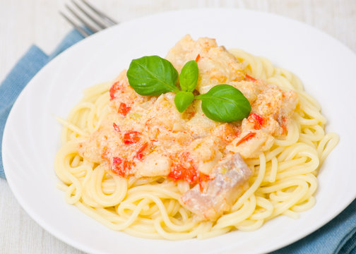 spaghetti with fish, vegetables and cream sauce