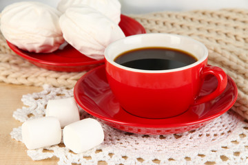 cup of coffee with scarf on table in room