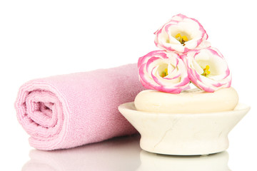 Fototapeta na wymiar Rolled pink towel, soap bar and beautiful flower isolated