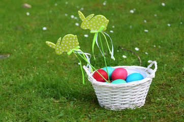 Easter bunny with eggs on a meadow in spring