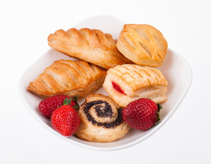 buns and strawberry on plate isolated