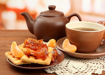 light breakfast with tea and homemade jam, on wooden table